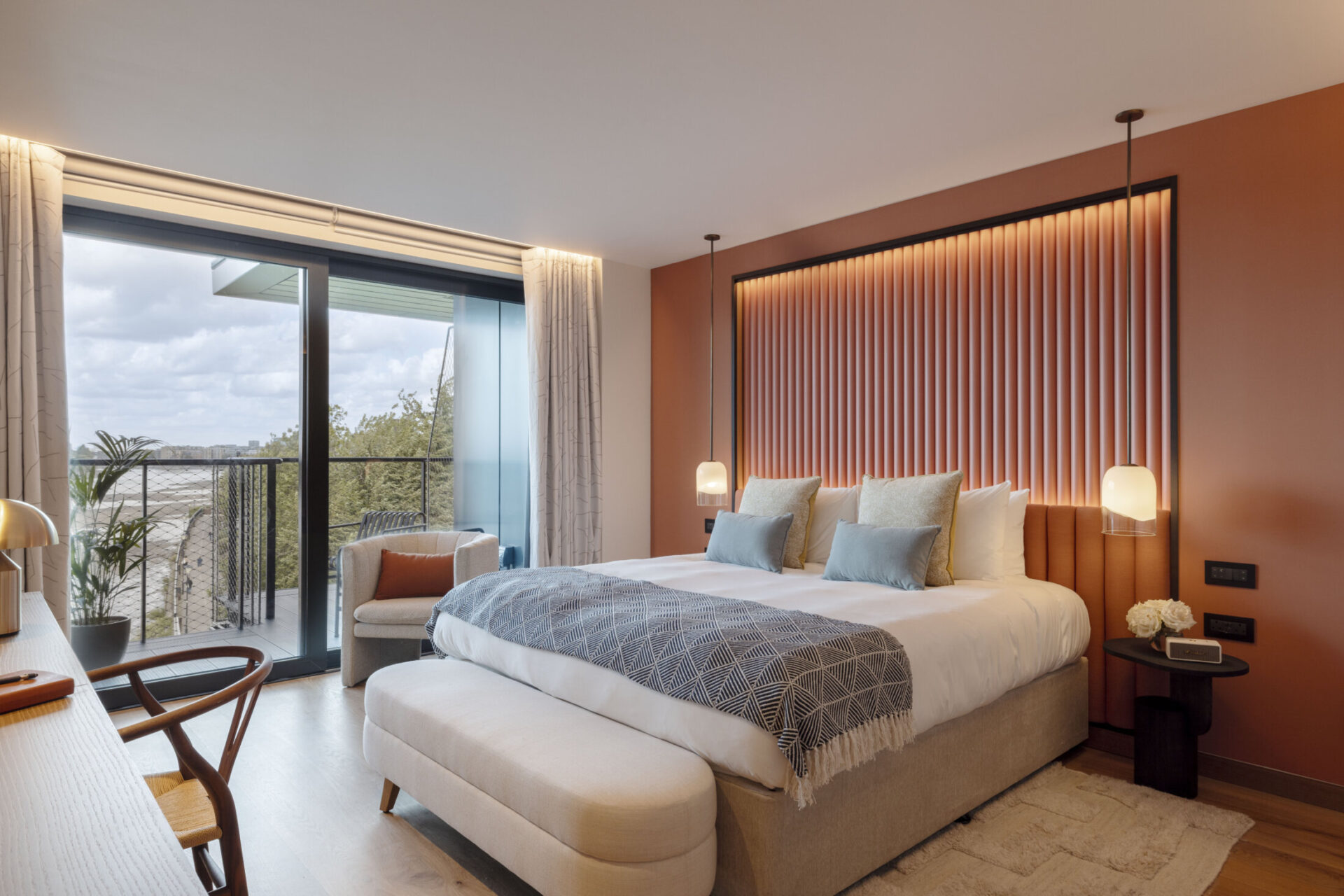 river ruby room with orange and red wallpaper and view of the thames