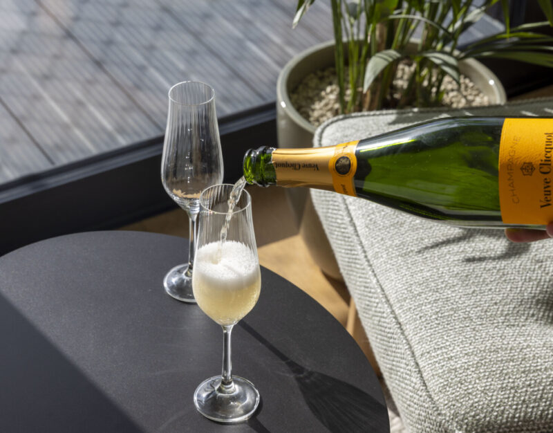 someone pouring champagne into flute